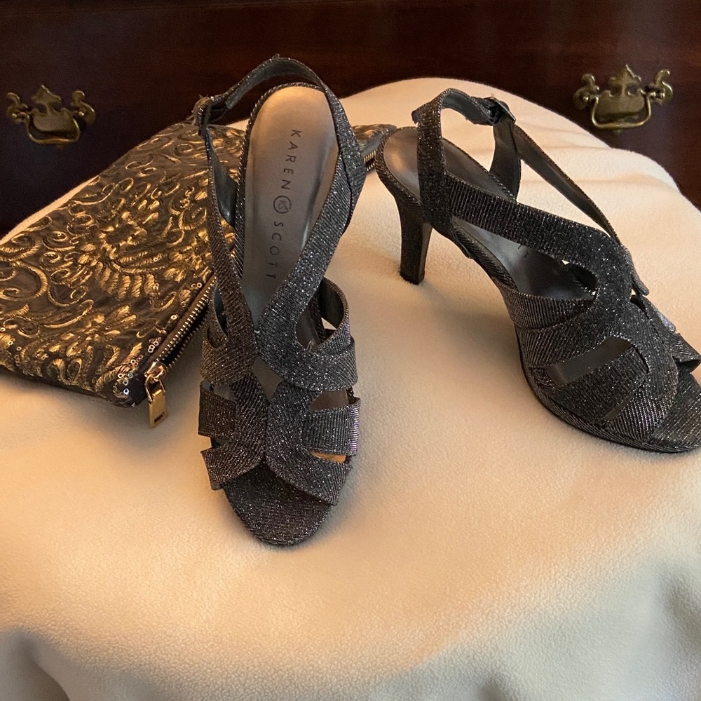 A pair of silver 3/4” heels and sequined clutch purse.